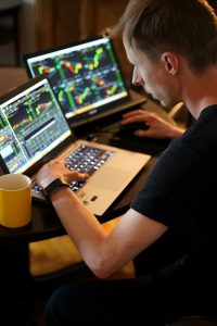 man sitting in front of the laptop